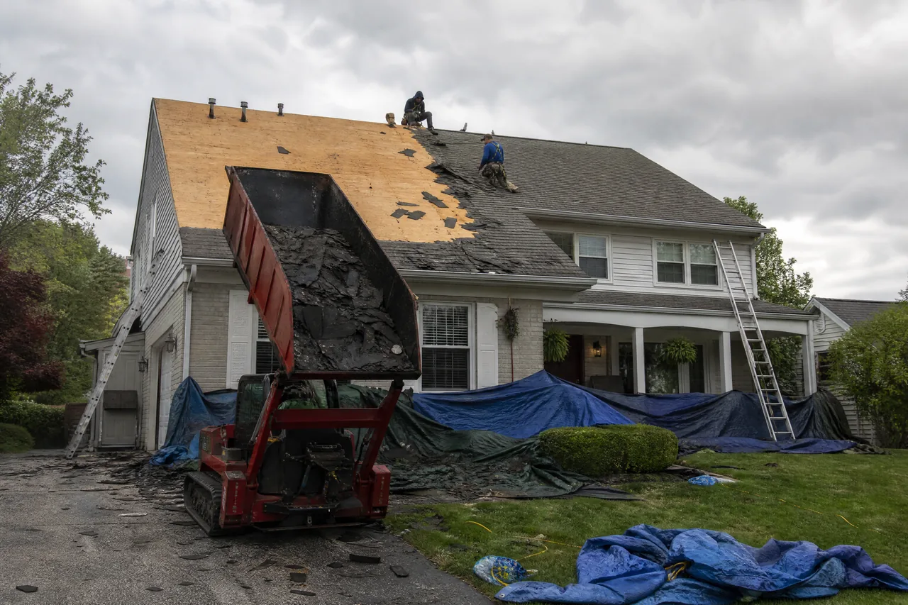 Tear-off in progress on an Aurora IL roof replacement with an Equipter in the driveway