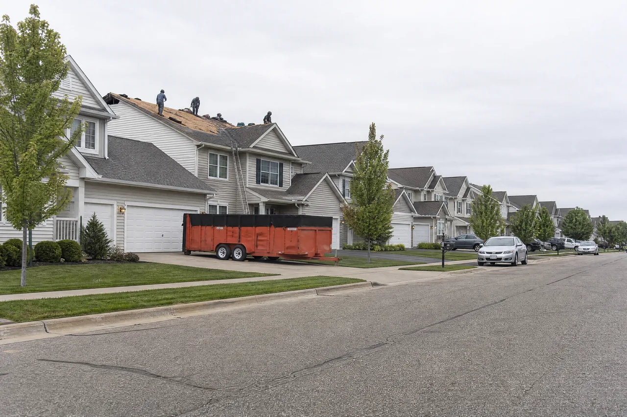 Re-roofing work on a 2000s-built subdivision street in Montgomery IL
